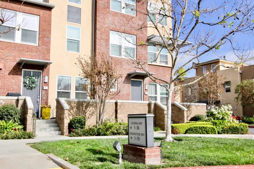 A sunny day in the Latitudes North with a apartment and trees.