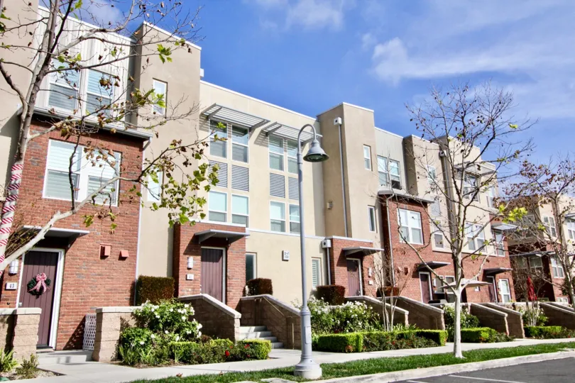 Villas with bright sunshine near street with lamps in Latitudes South of Aliso Viejo