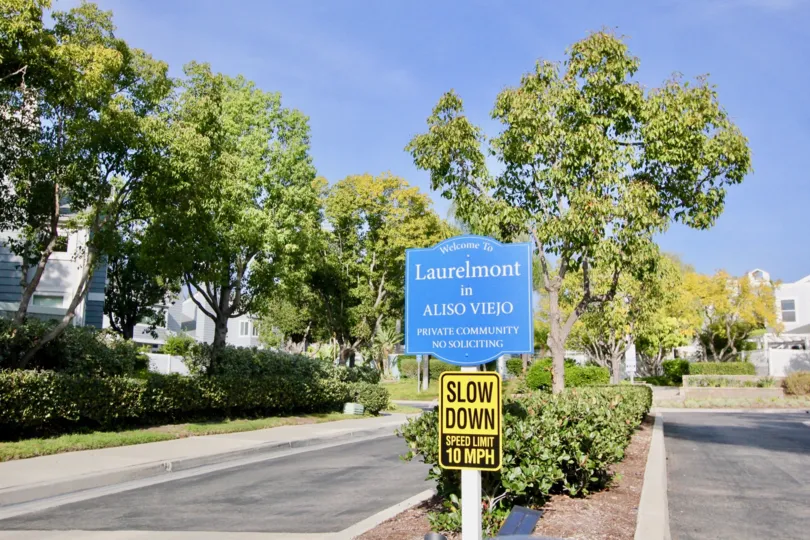 A great day in the Laurelmont with a sign and road.