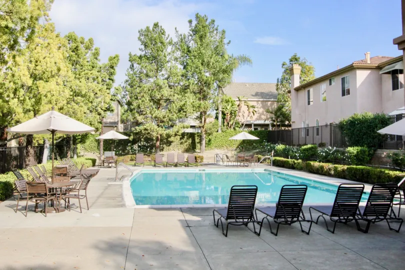 A bright day in the Milano with a swimming pool and chairs.