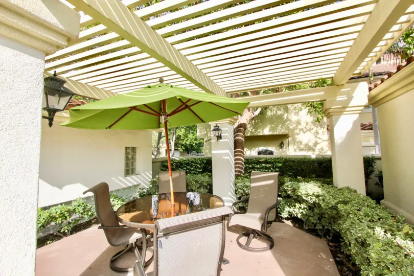 A beautiful courtyard portion of a building in the Montelena with a small table and two chairs also.