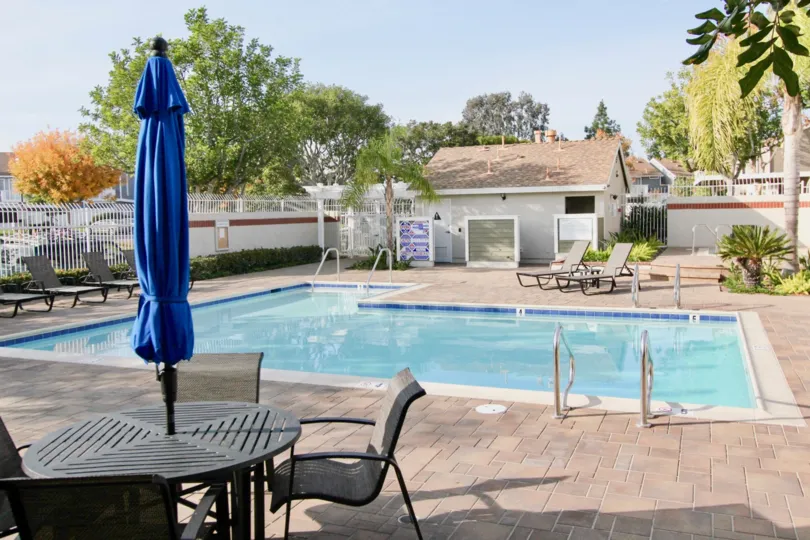 Private fenced-in pool with adjoining change rooms and stamped pattern deck at Morningside
