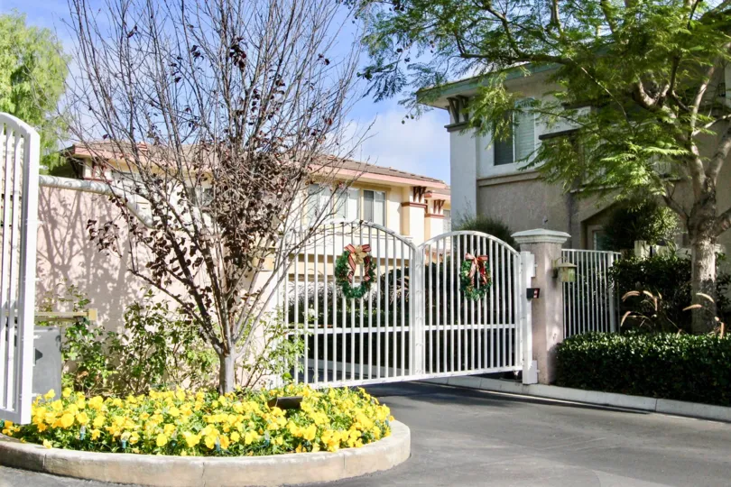 a warm day in the orleans wiht house that has out gate of tree, flowers