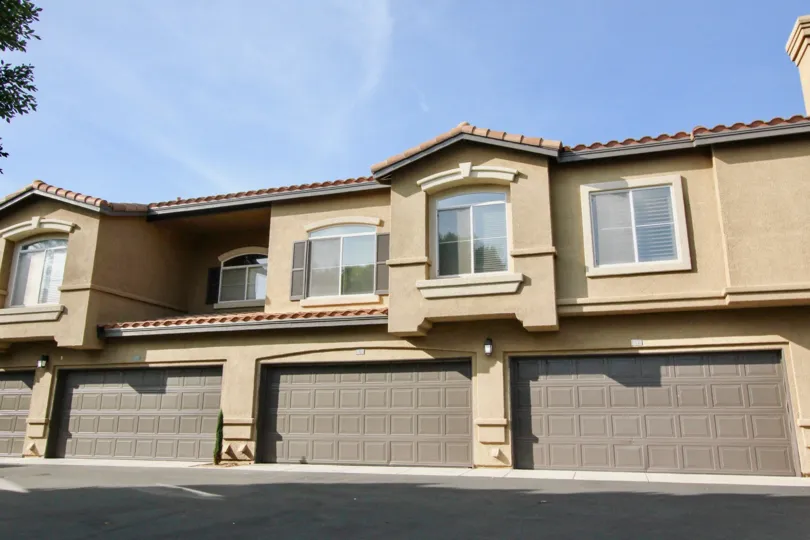 This Passeggio building features multiple garages on bottom and plenty of windows on top.
