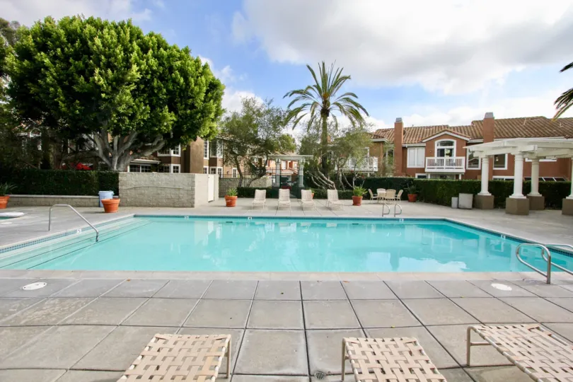 a warm day in the provence d'aliso with a building that has swiming pool at its centre