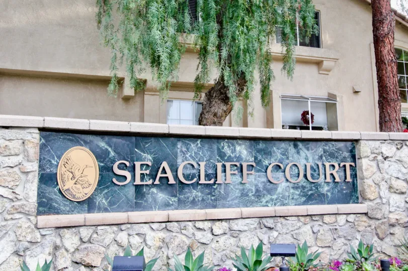 Sign with lighting and landscaping in front of the Seacliff Court community