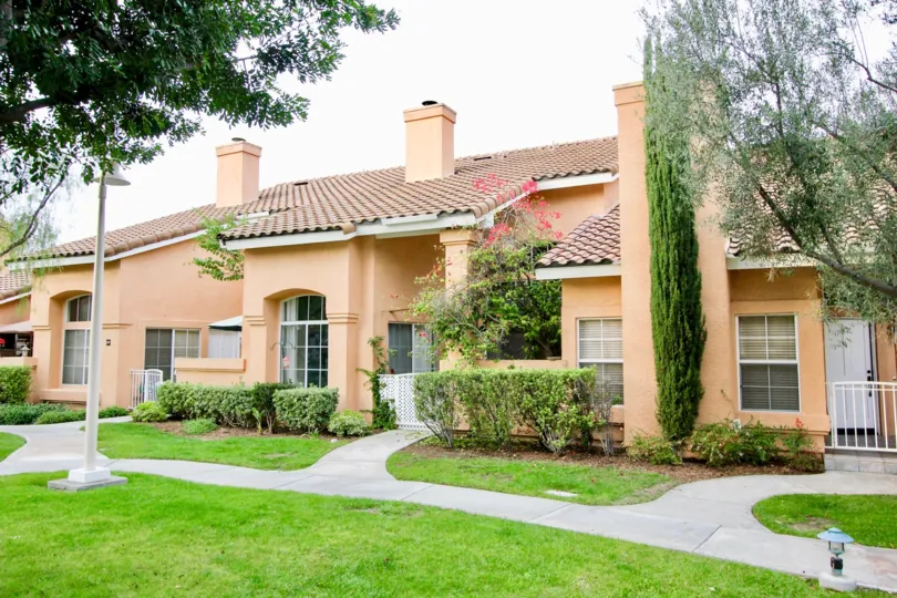 This is a beautiful home with a nice tile roof and a beautiful green yard