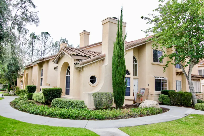 A circular sidewalk and towering plant welcome visitors to this unique Seacliff Court home.