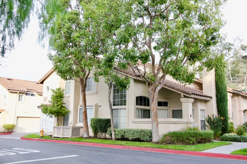 Driveway, trees and curb appeal view of building in the Seacliff Court community