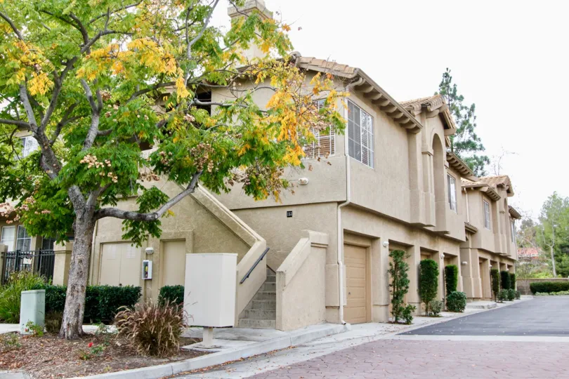 A unique side stairwell allows entrance to this khaki colored home in Seacove Place.