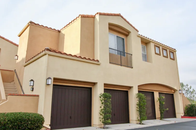 A stairway leads to a second floor area above four garages at the Seacove Villas community in Aliso Viego, California.