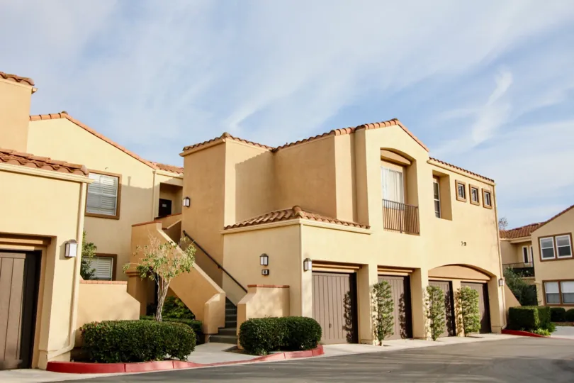 a sunny day in the seacove villas with a house that has its entrance in the left through a steps and has small plants in front