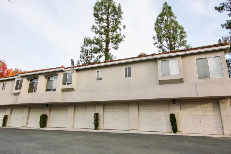 THE HOUSE IN THE SEAGATE COLONY WITH THE SHOPS, DISH ANTENNA, TREES