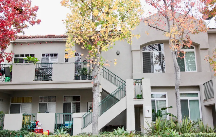 a warm day in the seagate colony with house that has front of colorful liefs on glass windows