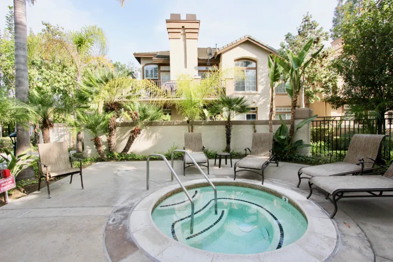 The jacuzzi at St. Tropez provides a relaxing escape for residents. The lush foliage and stylish enclosure provide privacy to this retreat.