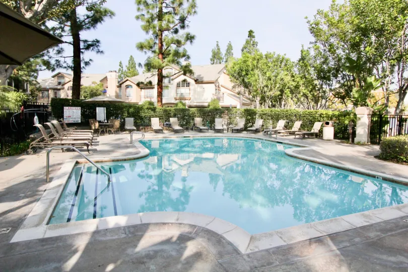 A giant luxurious pool with three steps inside the St. Tropez in Aliso Viejo CA