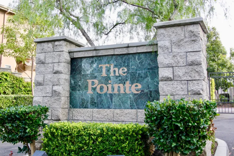 The entrance wall of the 'the point' with some shrubs and trees also.