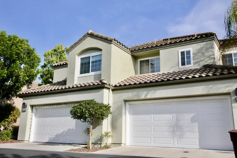 A beautiful grey color house back side in the The Villas with some small trees.