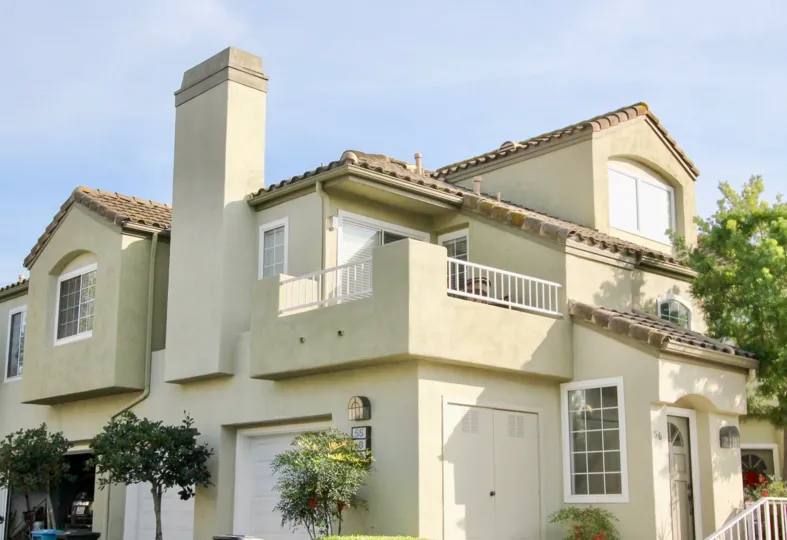 a warm day in the The Villas with house that has roofless top and storey