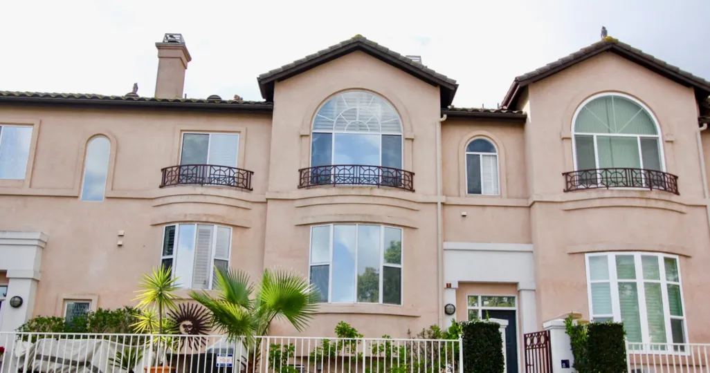 This quant Tivoli I street houses blooming trees and tall Spanish homes.
