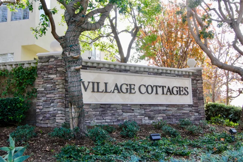 a warm day in the village cottages with building that has garden in front