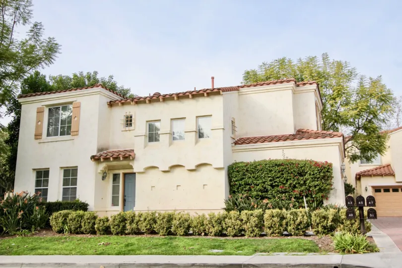 A bright day in the Vista De Oro with a house and plants.