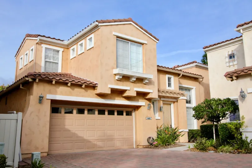 A sweet grey color building in the Vista De Oro with some shrubs and plants also.
