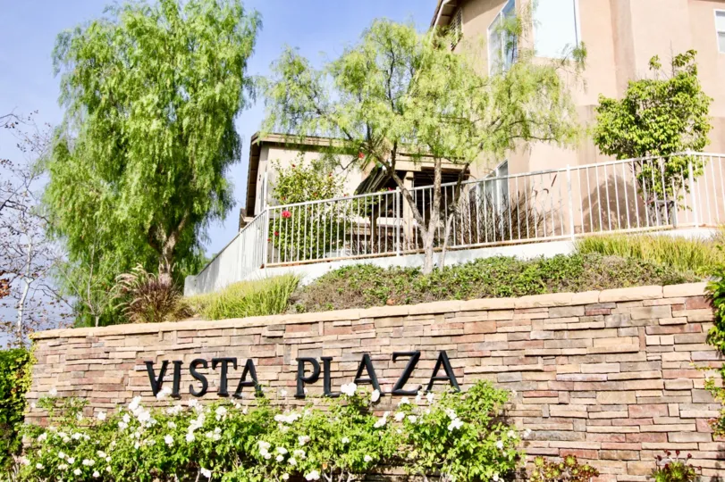 Wwall poster of' vista plaza' in the Vistas Plaza with some shrubs and trees.