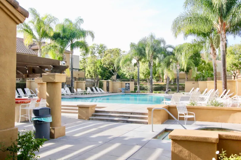Outdoor beach resort with swimming pool and lawn chairs