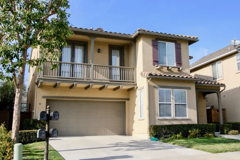 Sunny sky with a building and a tree in the Woodlands Community in Aliso Viejo, CA.