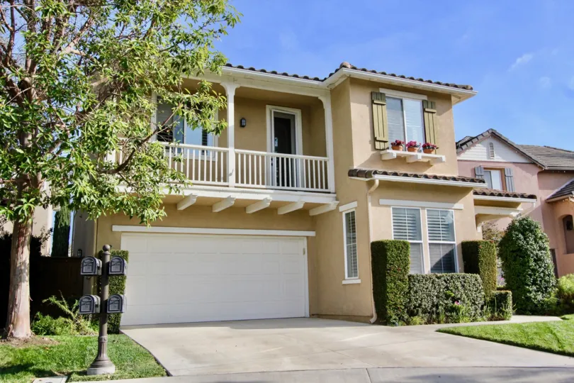 2 Storey single family home with front facing balcony, double car garage and decorative shutters with garden ledge in Woodlands