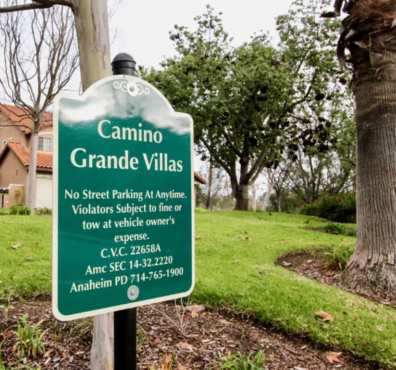 THE HOUSE IN THE CAMINO GRANDE VILLAS WITH THE CAMINO GRANDE VILLAS BOARD, PLANTS, TREES
