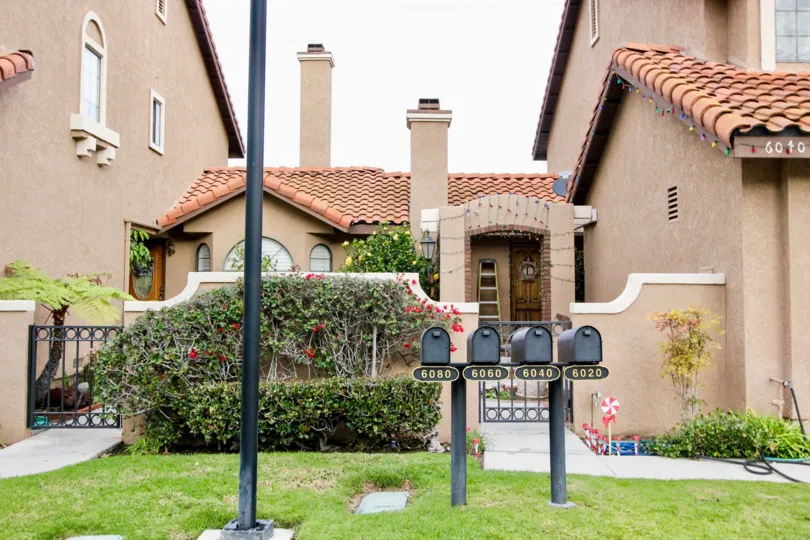 THE FRONT VIEW OF HOUSE WITH BEAUTIFUL LAWN, PLANTS WITH FLOWERS, ARE SHOWN IN THE ANAHEIM HILLS