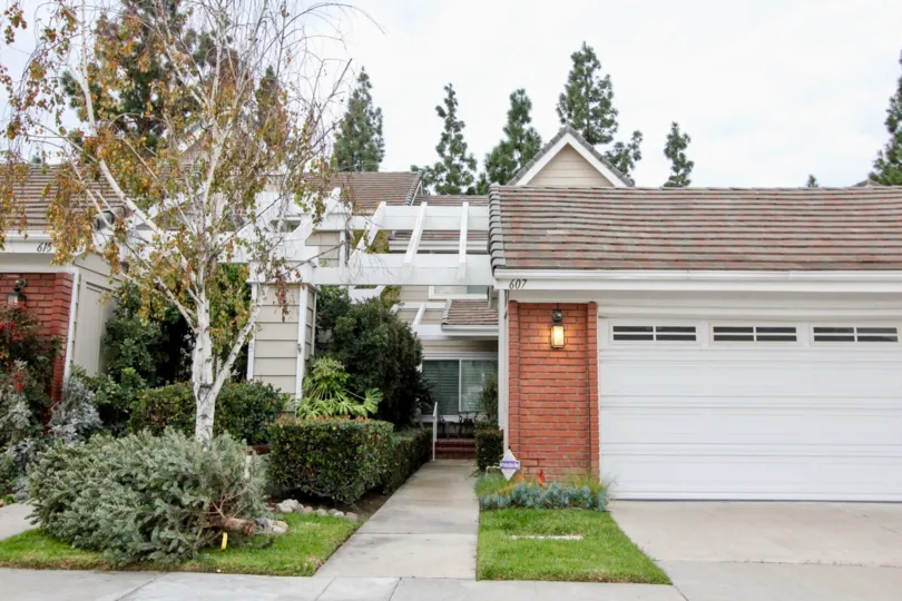 THE FRONT SIDE OF THE HOUSE WITH LAMP, TREES, PLANTS, PATHWAY ARE SHOWN IN THE CITY OF ANAHEIM HILLS