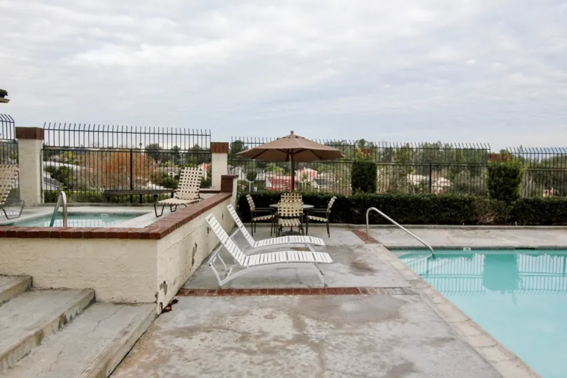 THE FLAT IN THE HAVENHILL WITH THE SWIMMING POOL, CHAIRS, PLANTS, TREES