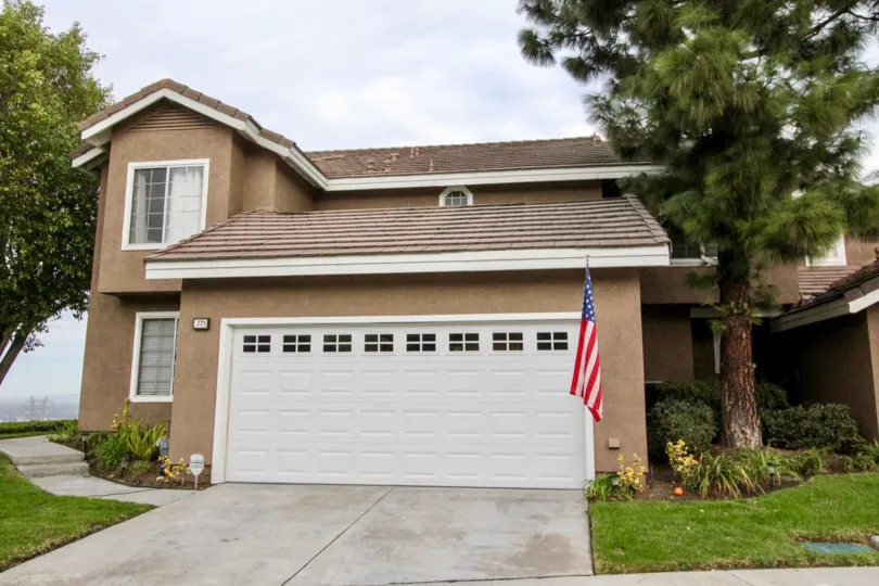 garage front view of the building having flag and decorate with plants in Horizons