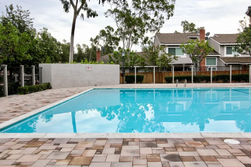 pool inside the compound wall near building decorated with trees and plants in Parkview Townhomes