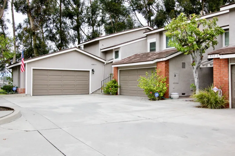 clean and clear area view in front garage near house having trees and plants around in Parkview Townhomes