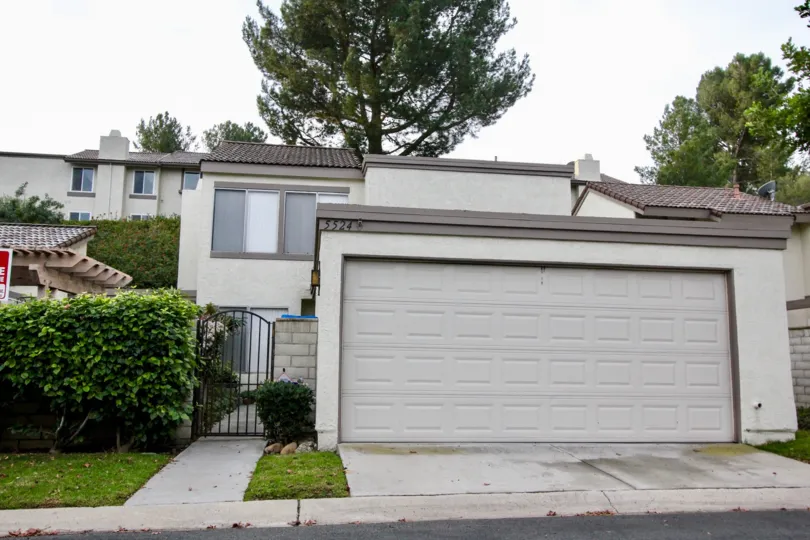 THIS SHOWS THE FRONT VIEW WITH SHED, PLANTS TREES, WHICH IS IN THE COMMUNITY OF RANCHO YORBA