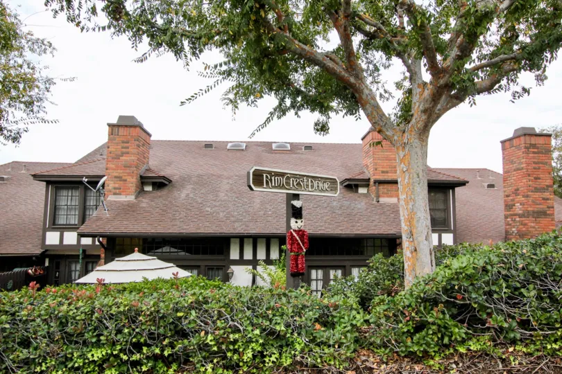 THE HOUSE IN THE RIMCREST VILLAS WITH THE RIMCREST DRIVE BOARD, TREES, PLANTS