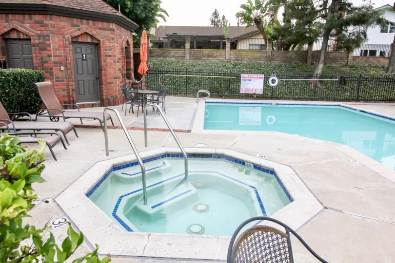THE FLAT IN THE RIMCREST VILLAS WITH THE SWIMMING POOL, CHAIRS, PLANTS, TREES