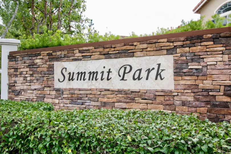 A sunny day in the Summit Park with a compound wall constructed with marbles