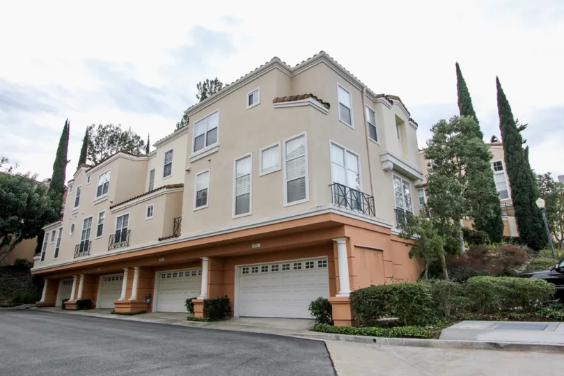 A three story building with a garage at it's base inside Summit Renaissance in Anaheim Hills CA
