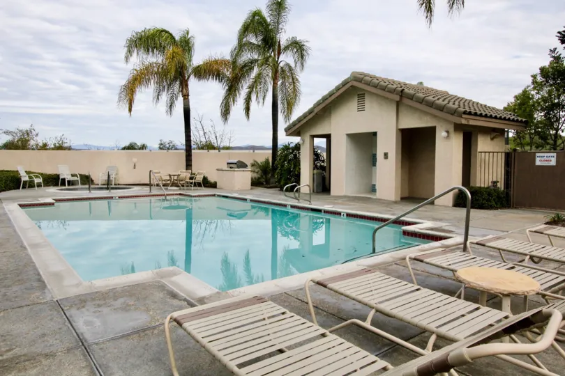 THIS IMAGE REPRESENTS THE SWIMMING POOL WITH CHAIRS, RESTING ROOM, TREES ARE VIEWED IN THE VIEWPOINTE NORTH