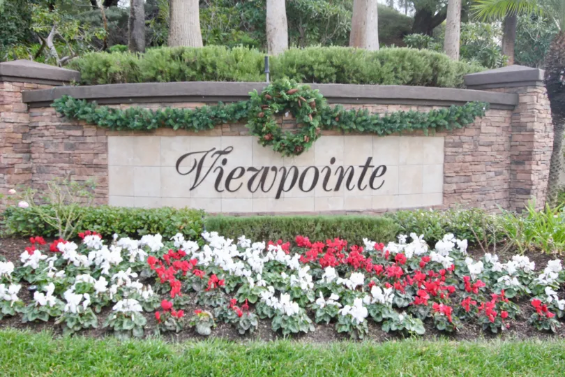 a warm day in the viewpointe with building that has stone walls and garden around in the flower