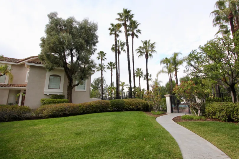 a warm day in the viewpointe with building that has roofless top and garden around