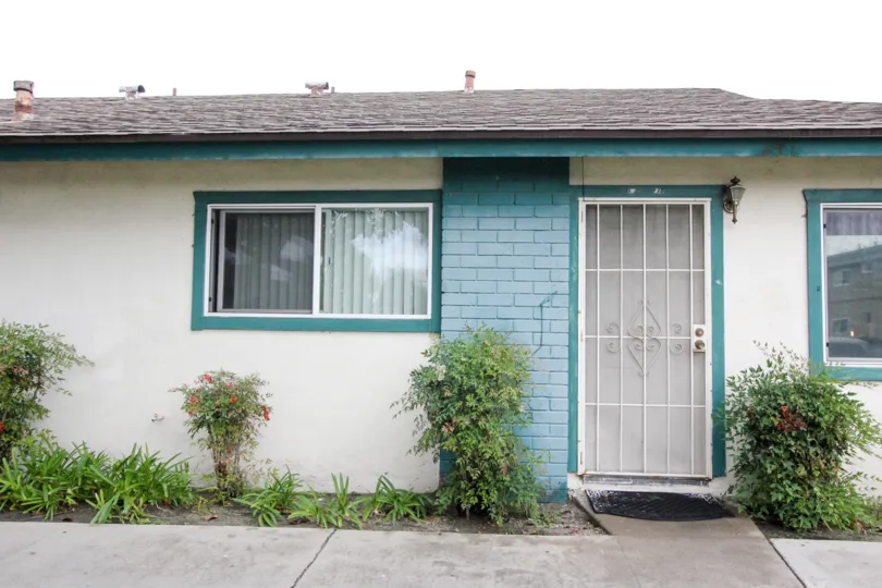 A plain bungalow in the 1152 North West community with turquoise details.