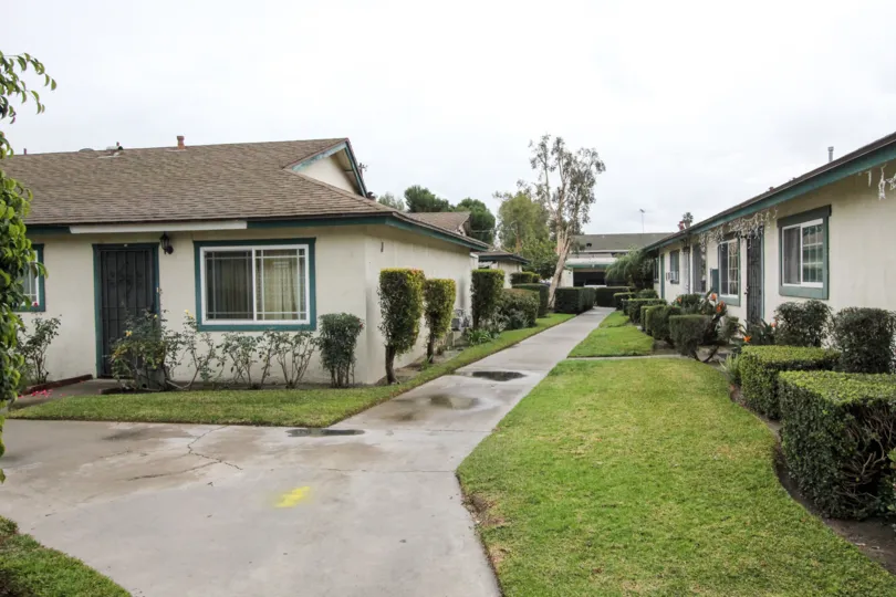 A paved path way leads through a group of houses in Anaheim California.