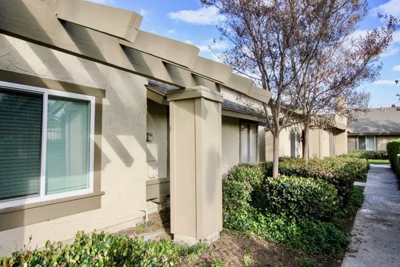 The exterior path, entry and landscaping at Anaheim Gardens on a sunny day