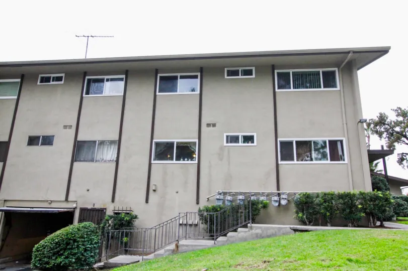 Front to the Apartment in Anaheim Village I has stairs way with meadows and plants